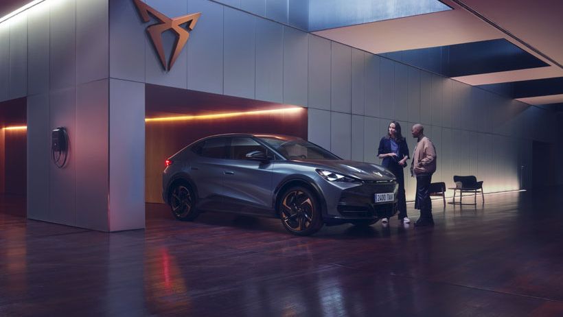 A sales person and a customer in CUPRA Showroom with a CUPRA Tavascan