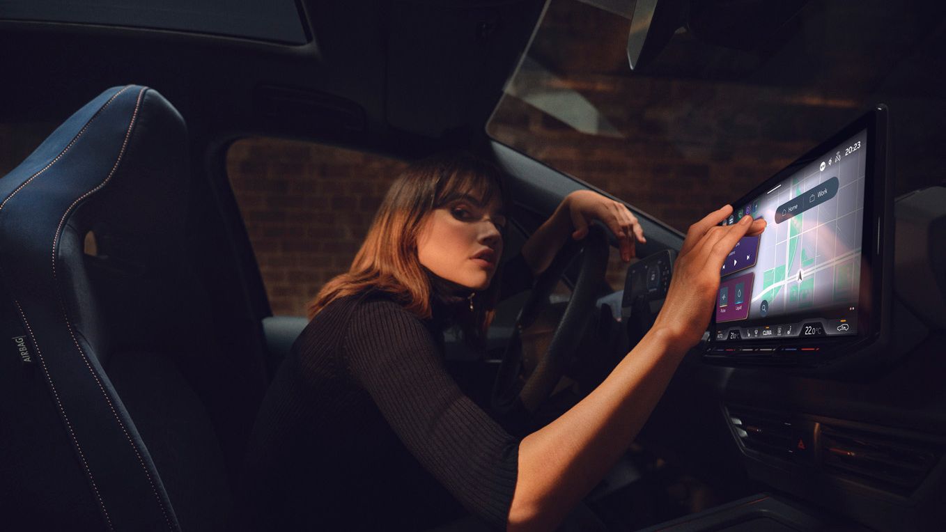 A lady using the infotainment screen in CUPRA Born