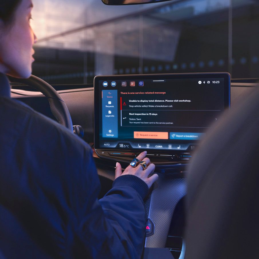 A lady in CUPRA Tavascan using the infotainment