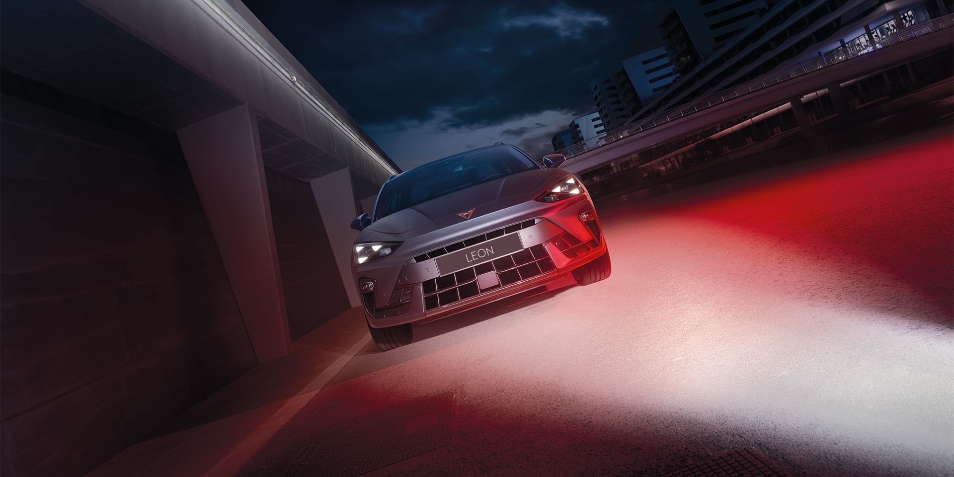 CUPRA Leon parked by the side with red light shining over on the side