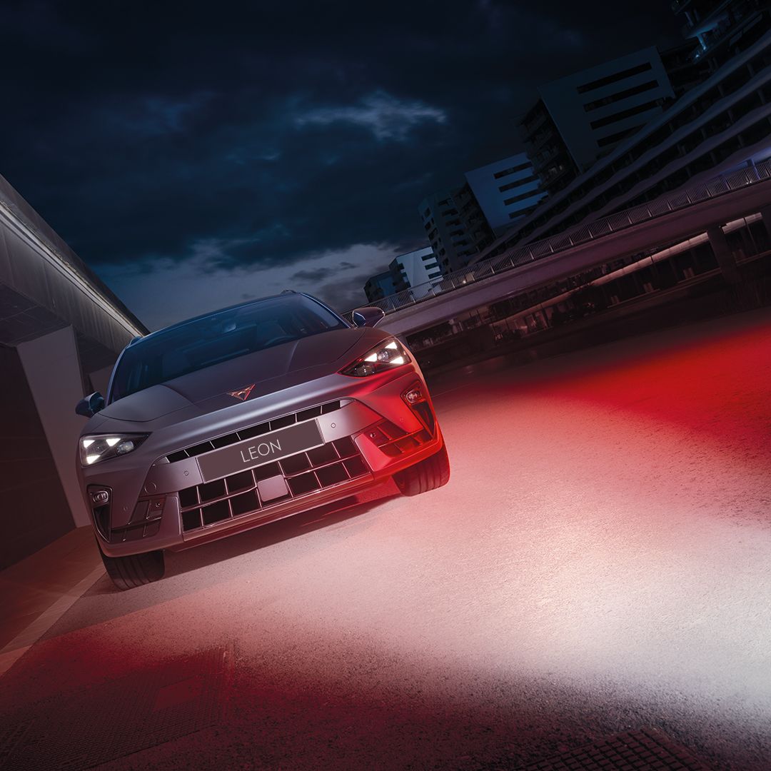 CUPRA Leon parked by the side with red light shining over on the side