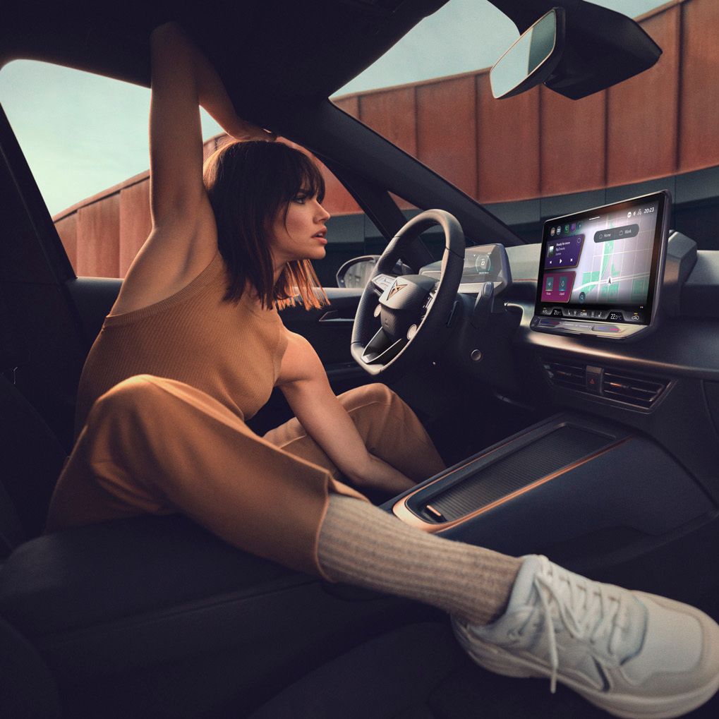 A lady sitting in CUPRA Born