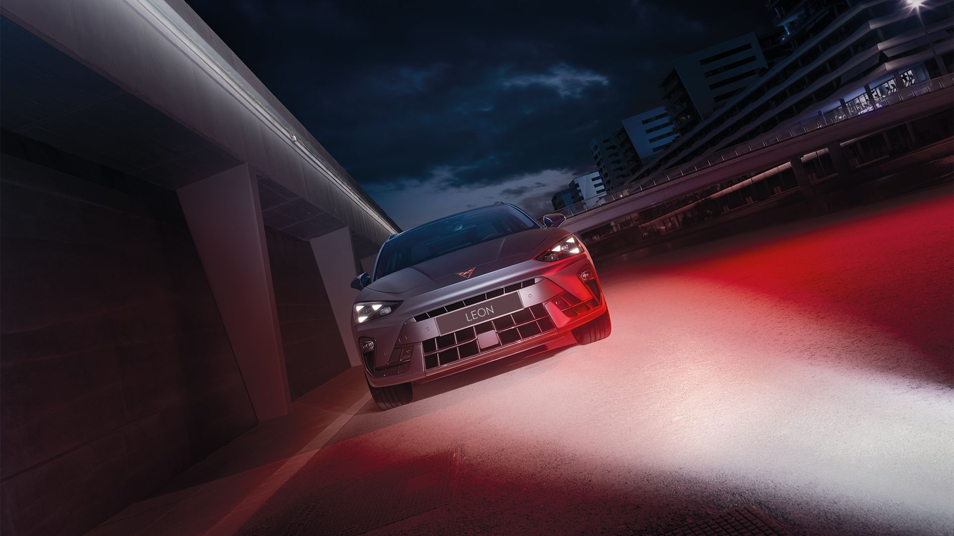 CUPRA Leon parked by the side with red light shining over on the side