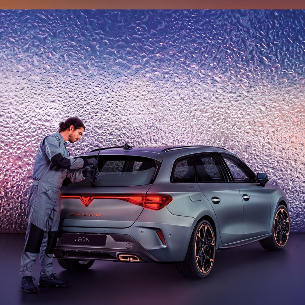 A CUPRA Servicing crew attending to the rear wiper of a CUPRA Leon