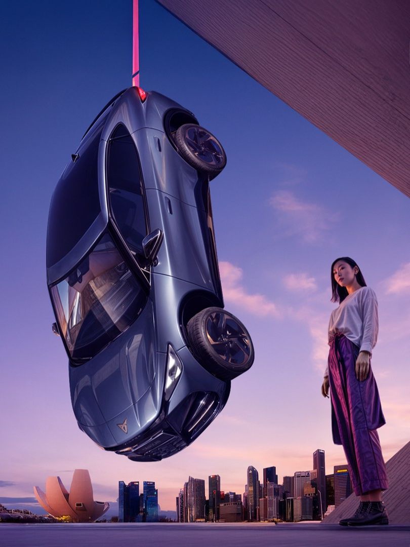 CUPRA Tavascan hanging by the Singapore CIty view with a Singaporean lady standing beside
