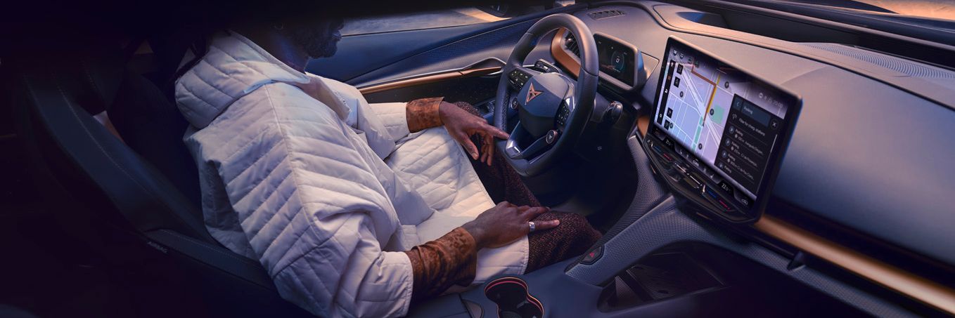 A guy sitting in CUPRA Tavascan driver seat