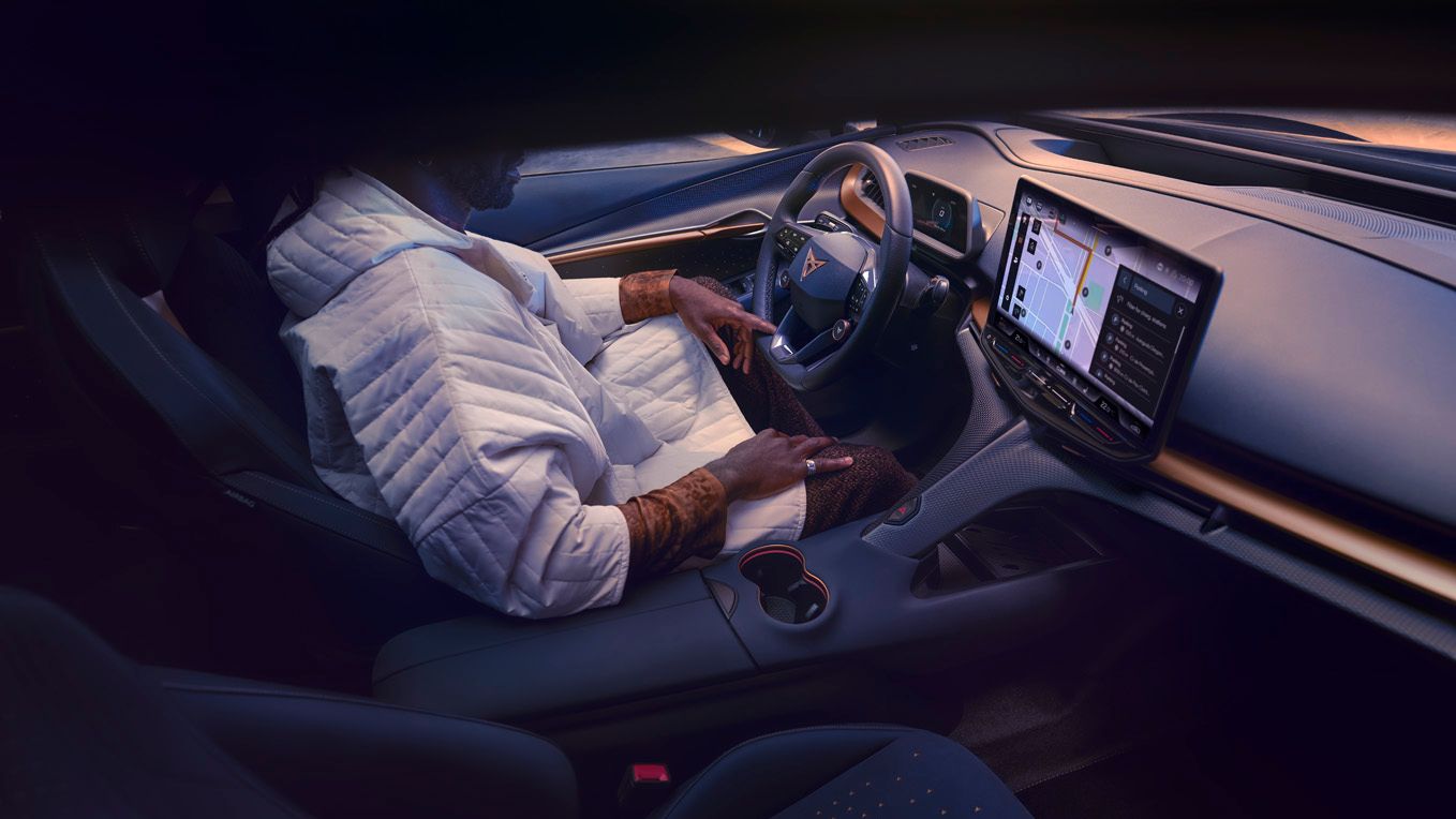 A guy sitting in CUPRA Tavascan driver seat