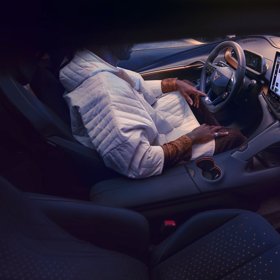A guy sitting in CUPRA Tavascan driver seat