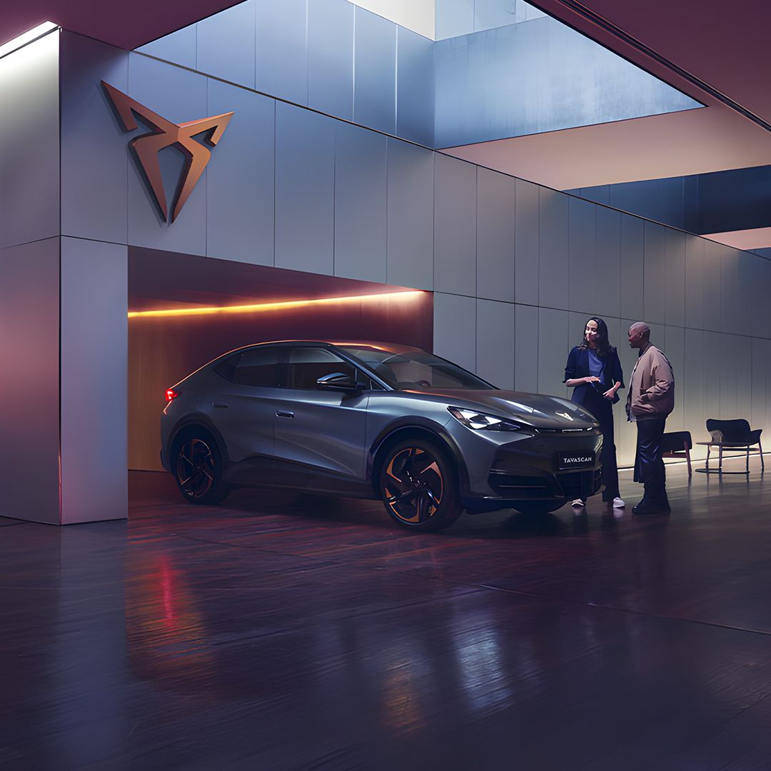 A CUPRA Sales associate showing a customer CUPRA Tavascan