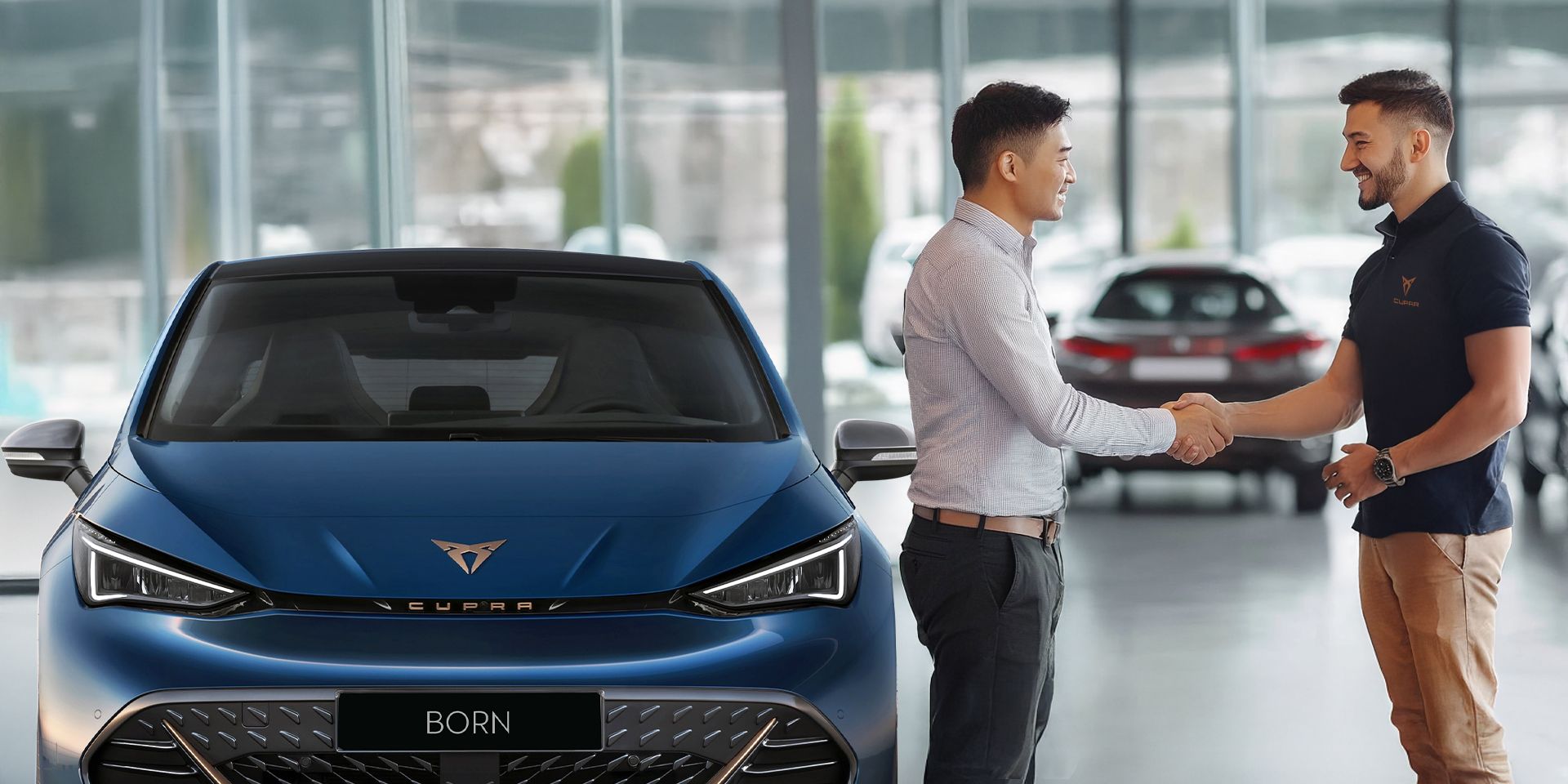 A CUPRA Sales man shaking hands with a buyer for CUPRA Born