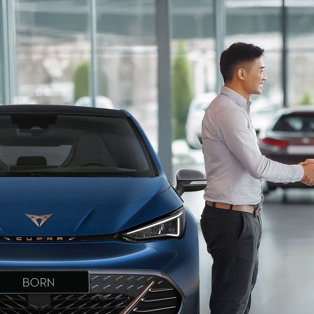 A CUPRA Sales man shaking hands with a buyer for CUPRA Born