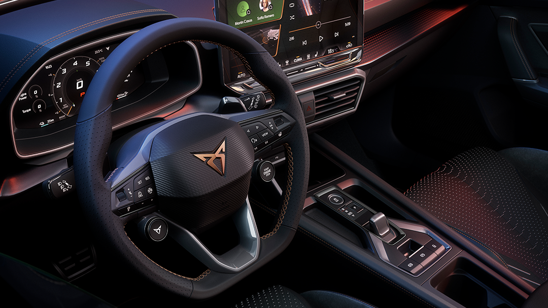 CUPRA Leon interior view from driver seat showing the steering wheel and infotainment screen