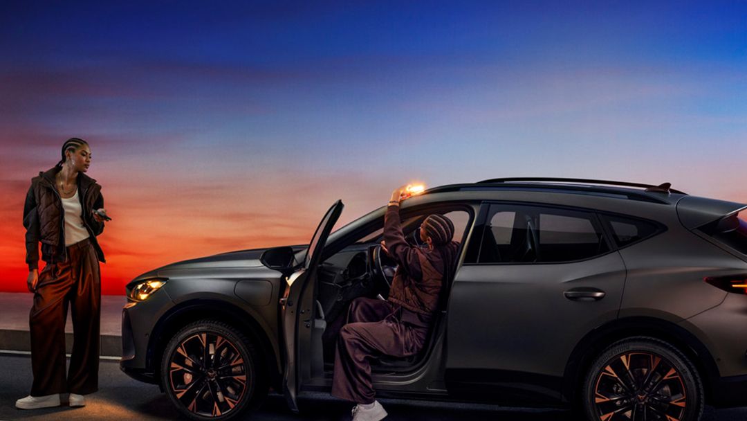 Two girls checking CUPRA Formentor by the side of the road