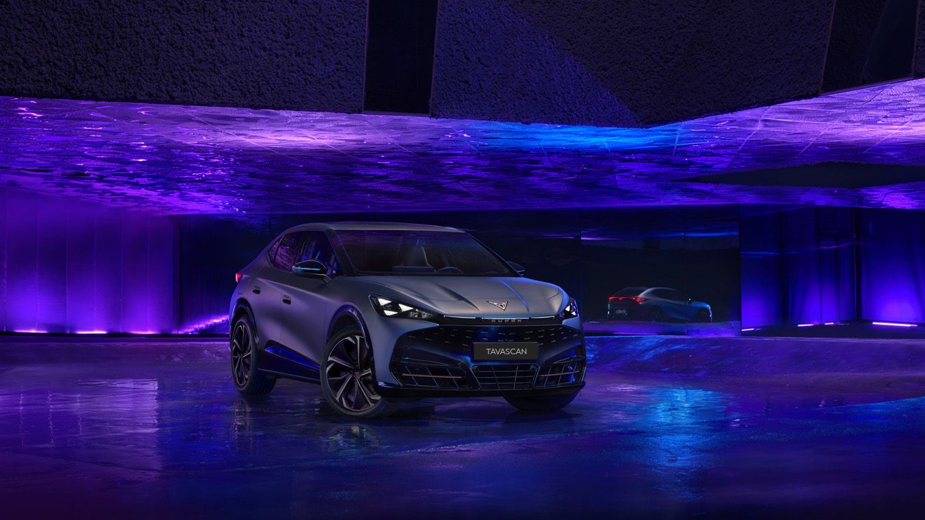 Showcasing CUPRA Tavascan exterior in an dark indoor purple and blue studio