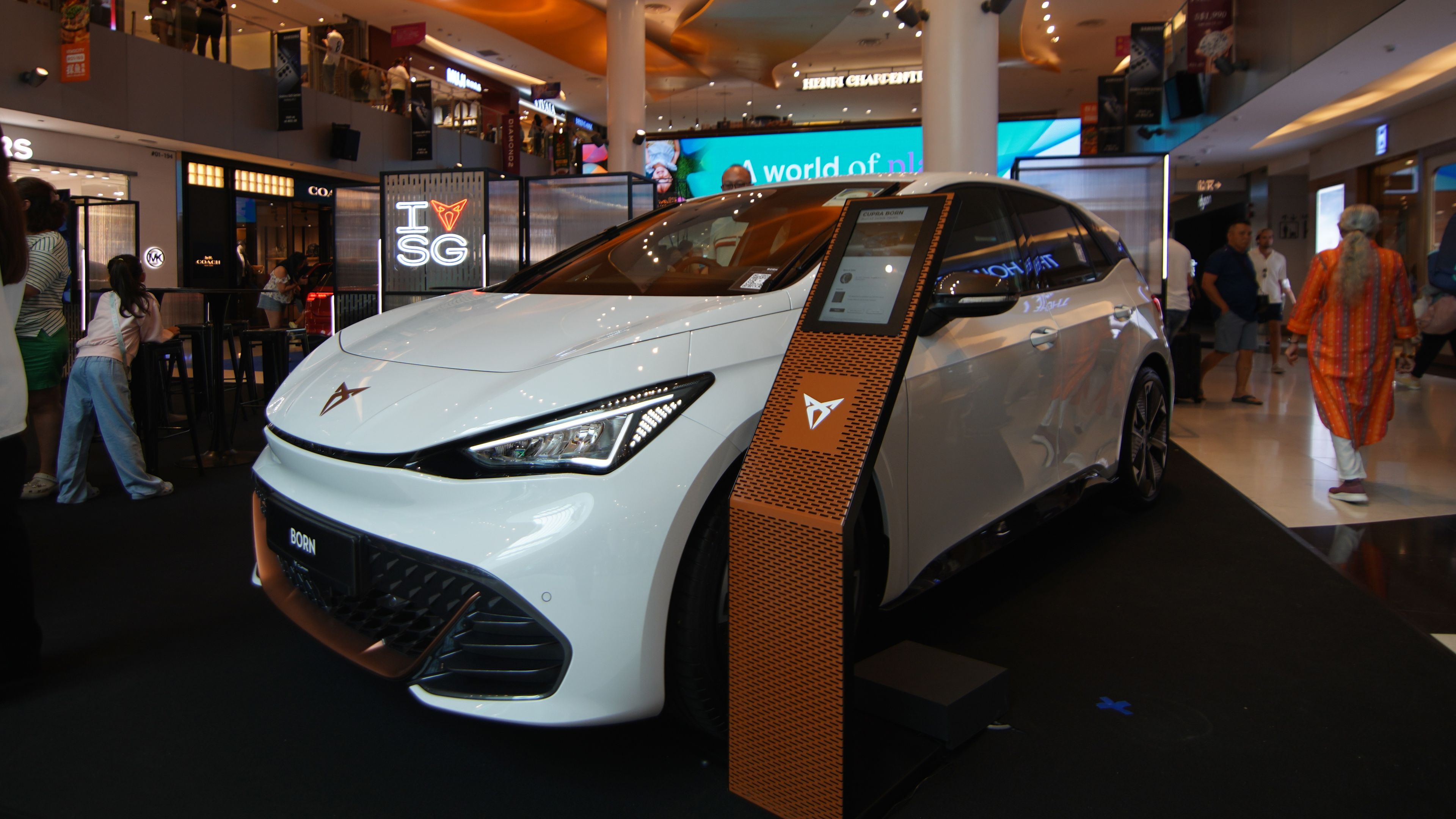 CUPRA Born at the roadshow with silent salesman by the side of the car