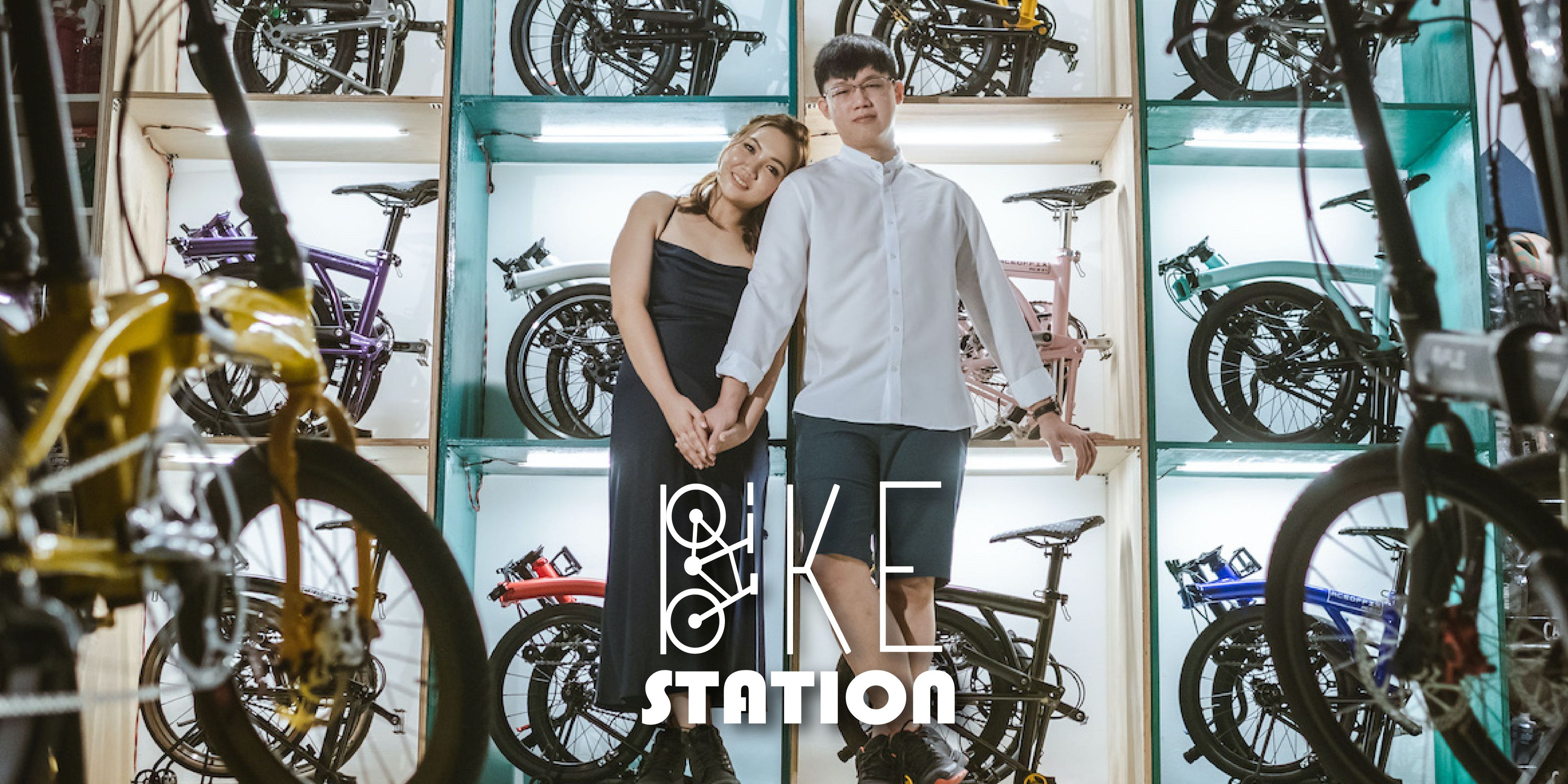 A couple holding hands in a bike store
