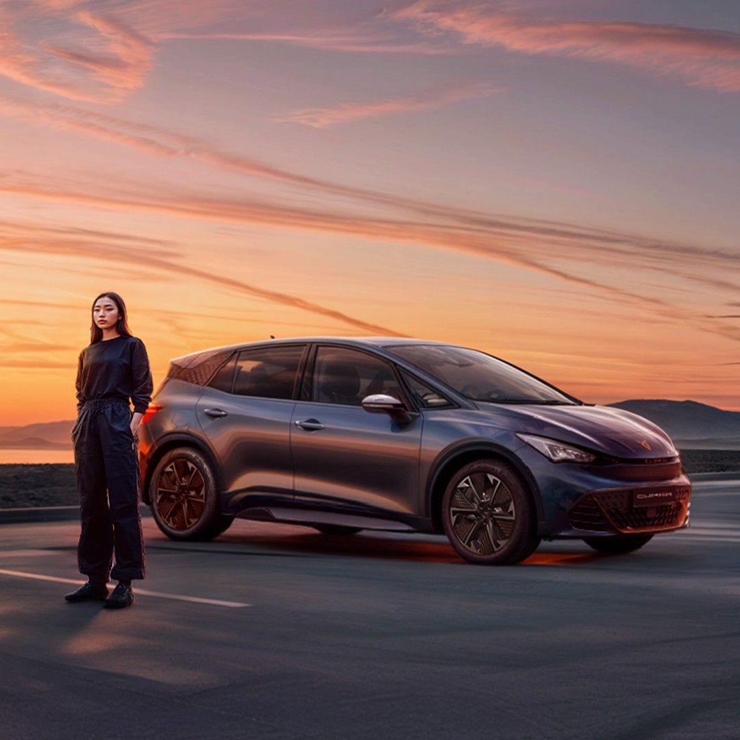 A girl standing beside CUPRA Born
