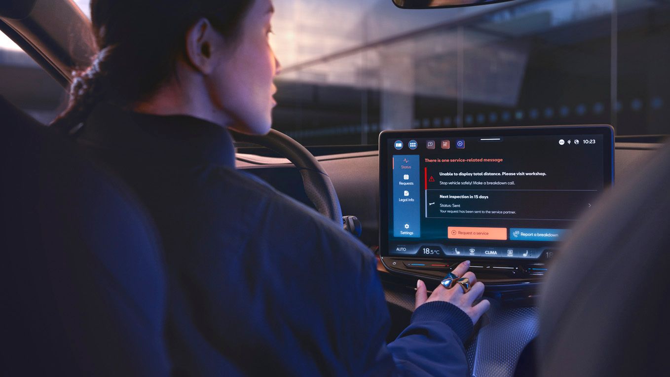 A lady in CUPRA Tavascan using the infotainment