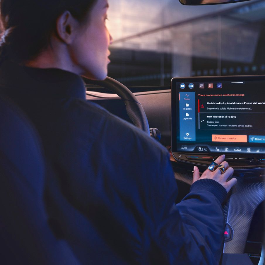A lady in CUPRA Tavascan using the infotainment