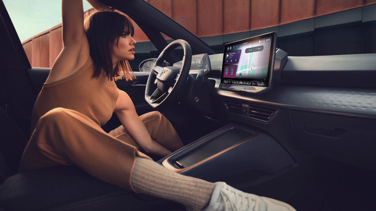 A lady sitting in CUPRA Born