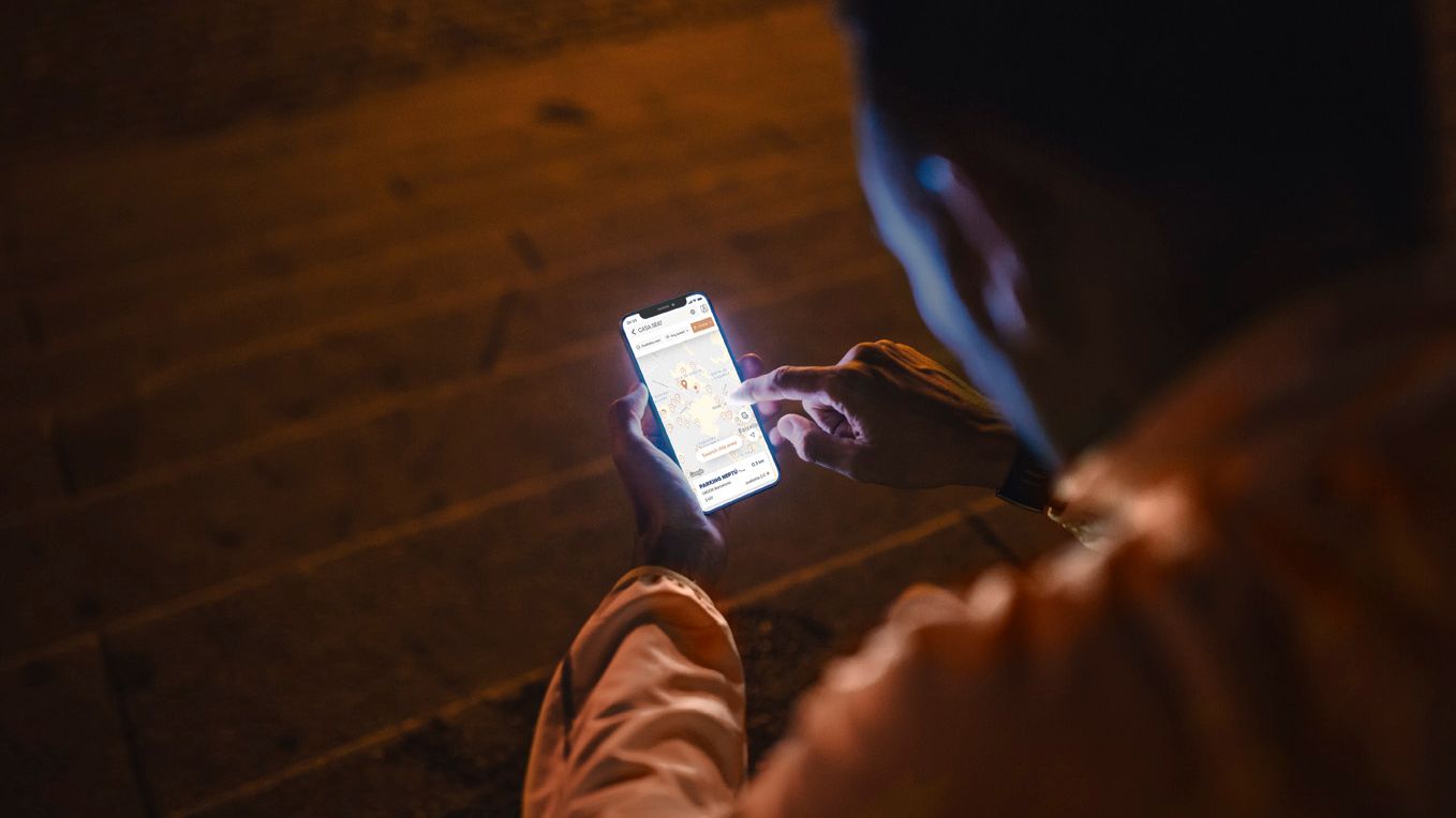 A guy interacting with his phone looking on the location map