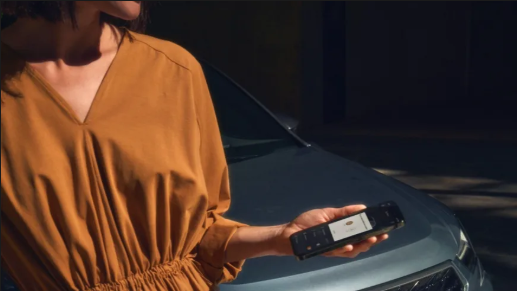 A lady holding her phone beside a CUPRA Formentor