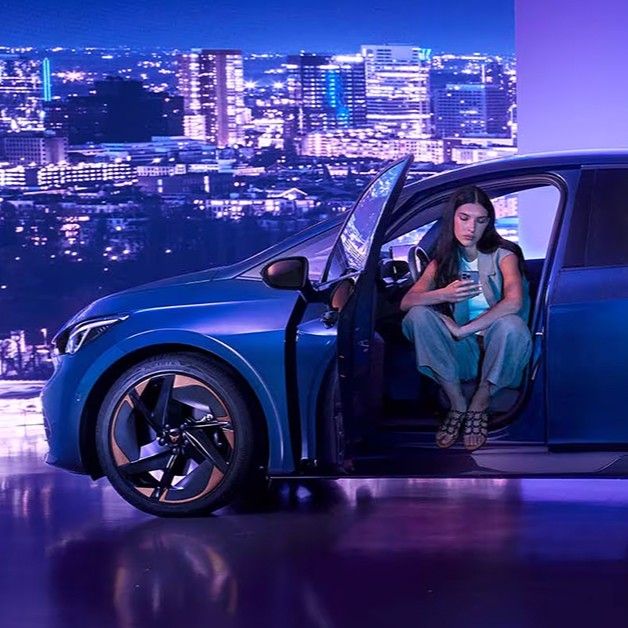 A lady sitting in CUPRA Born with the doors open