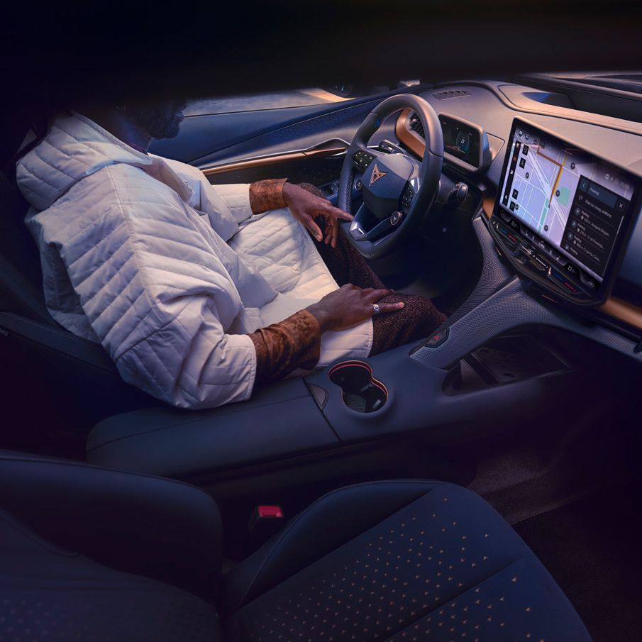 A guy sitting in CUPRA Tavascan driver seat