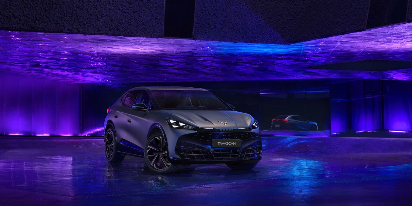 Showcasing CUPRA Tavascan exterior in an dark indoor purple and blue studio