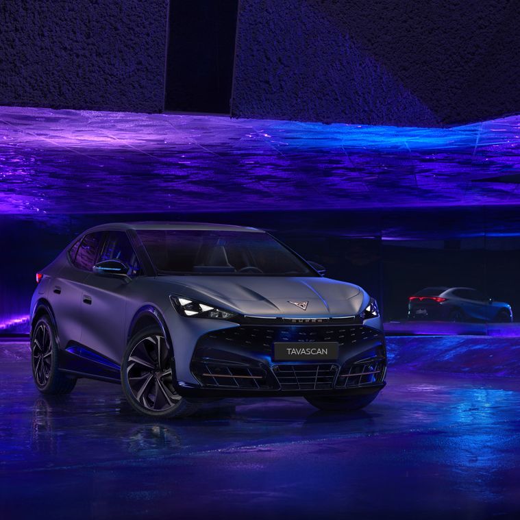 Showcasing CUPRA Tavascan exterior in an dark indoor purple and blue studio