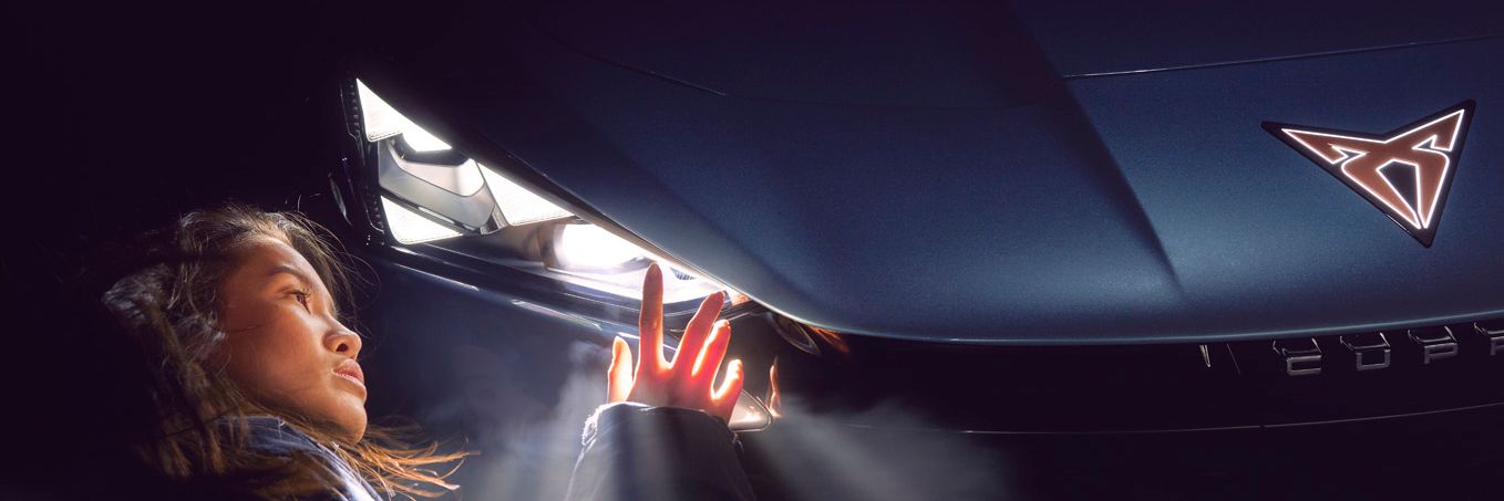 A lady admiring the CUPRA Tavascan headlights