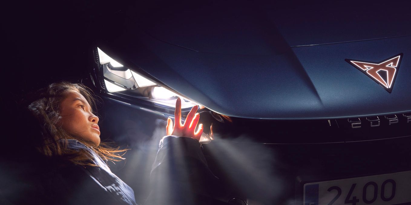 A lady admiring the CUPRA Tavascan headlights