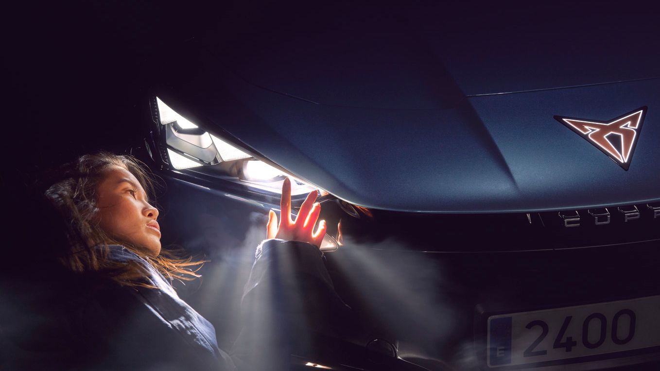 A lady admiring the CUPRA Tavascan headlights