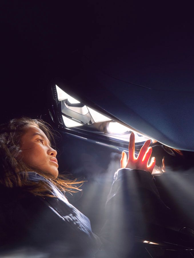 A lady admiring the CUPRA Tavascan headlights