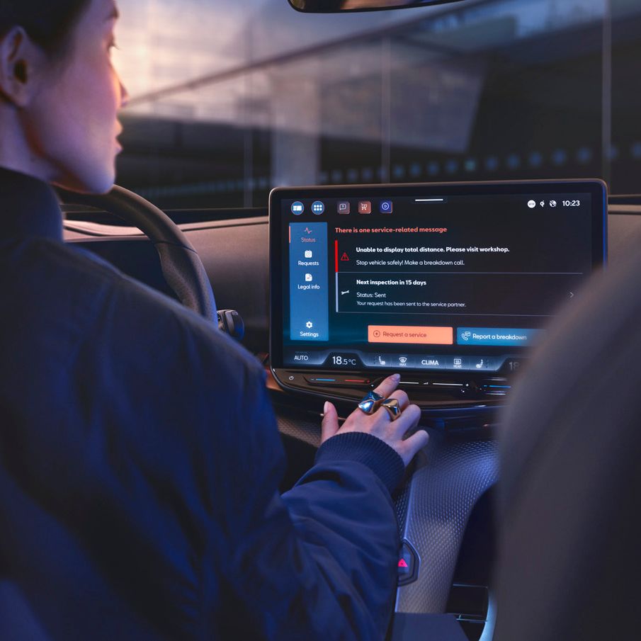 A lady in CUPRA Tavascan using the infotainment